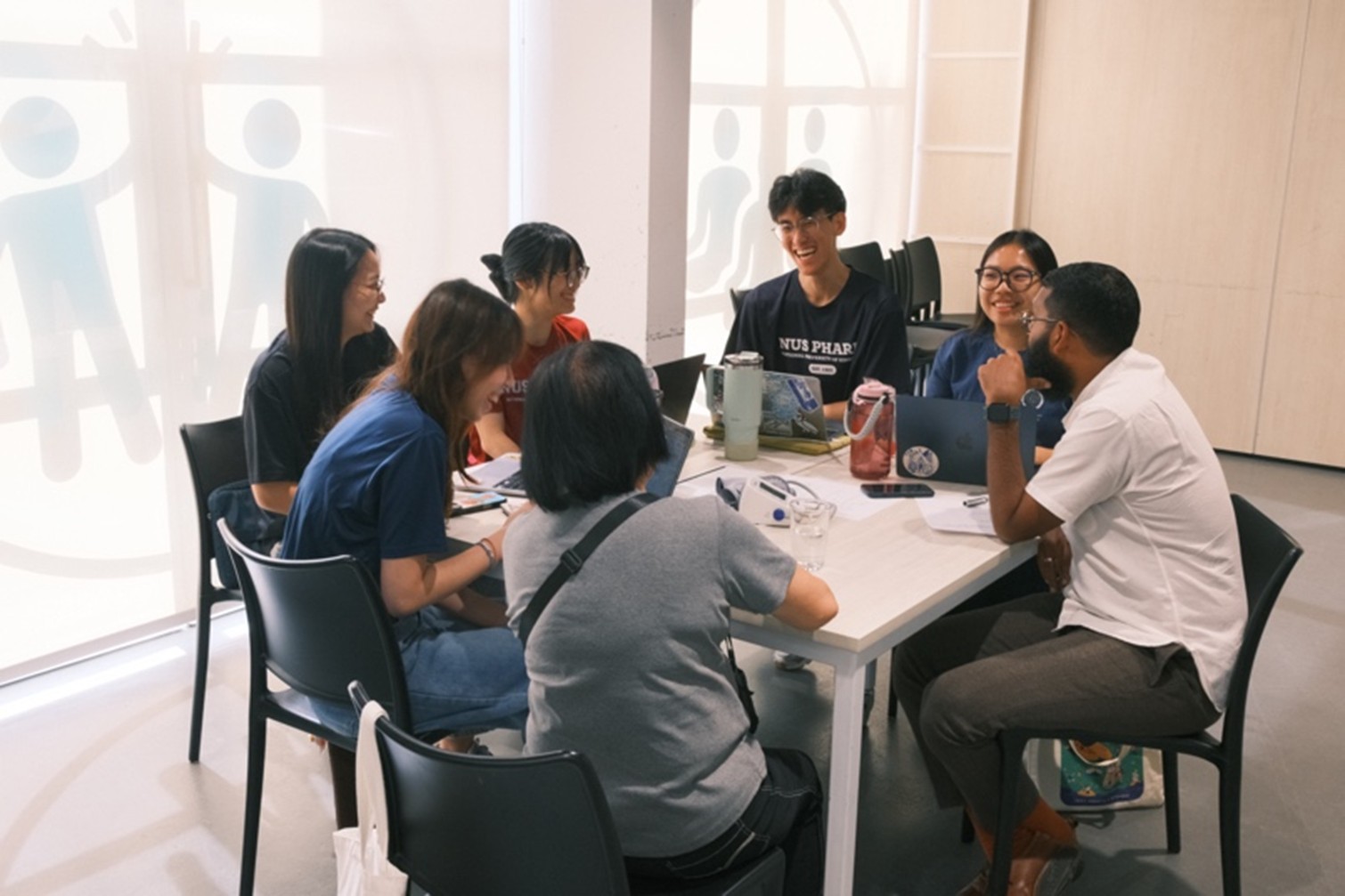 Jollene Ng (Y3), Tiffany Chung (Y3), Ainsley Tan (Y2), Gabriel Ong (Y2), Tricia Tan (Y2) and pharmacist mentor Mr Imran Shah sharing a light-hearted moment with their client.